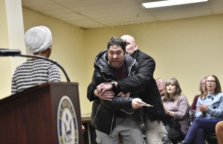 Rep. Ilhan Omar rushed on stage and sprayed with liquid at town hall event